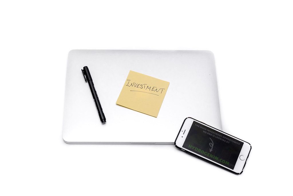 Investment sticker, laptop and smartphone (digital marketing analytics laptop)